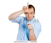 stock-photo-closeup-portrait-of-funny-young-man-displaying-a-loser-sign-on-his-forehead-and-p...webp