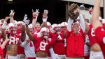 041214-CFB-huskers-bo-pelini-leads-team-out-of-tunnel-with-cat-ahn-PI.jpg