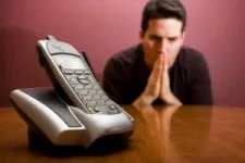 man-waiting-by-phone-300x200.webp