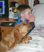 dog_praying_with_a_kid.webp