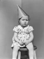 h-armstrong-roberts-girl-wearing-dunce-cap-sitting-on-stool-in-corner.webp