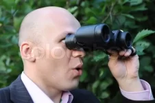 3532633-man-looking-through-binoculars.webp