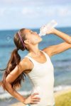 20560263-fitness-woman-drinking-water-after-running-at-beach-thirsty-sport-runner-resting-taking.jpg